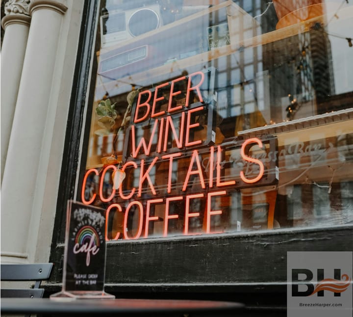 Neon sign in cafe window reads, "BEER / WINE / COCKTAILS / COFFEE"